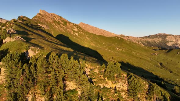 Dolomites mountains peaks with a hiking path on a summer sunrise