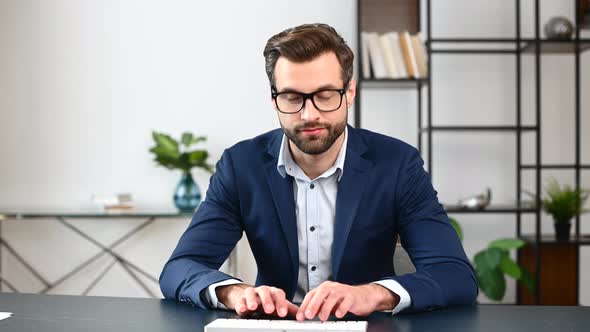 Successful Young Bearded Businessman with Laptop