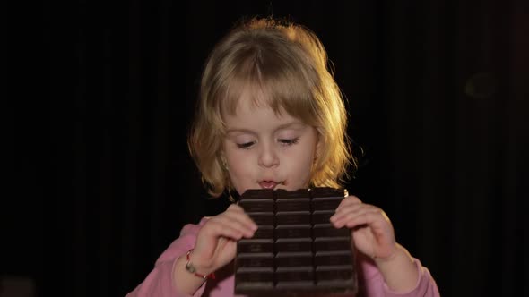 Attractive Child Eating a Huge Block of Chocolate