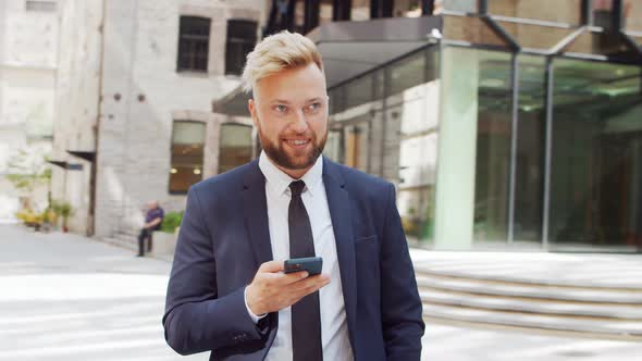 Confident businessman in front of modern office building. Financial investor outdoor.