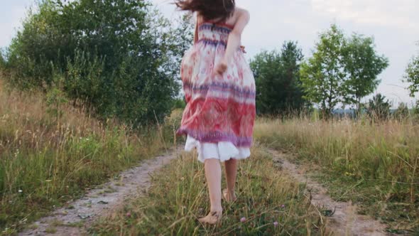 Little girl walking on rural road