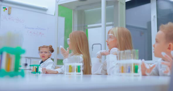 Group of Kids Making Experiments in Chemistry Class