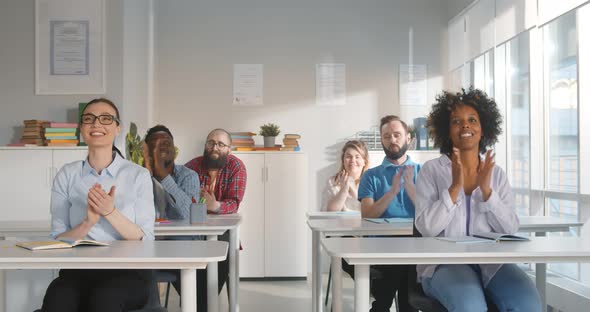 Group of Happy Students Applauding to Lecturer While Attending Class at University Classroom