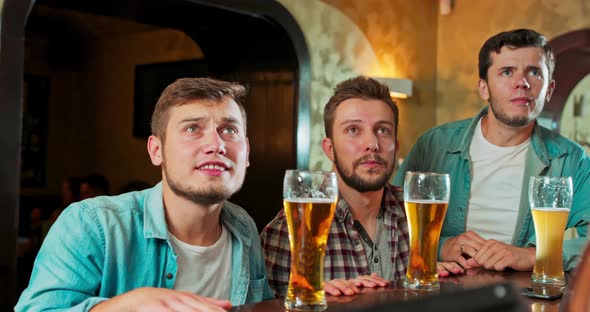 Diverse Group of Friends Watches TV in the Sporstbar Their Team Scores the Goal and