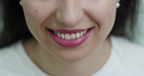 Smiling Female Mouth with Natural White Teeth Selective Focus