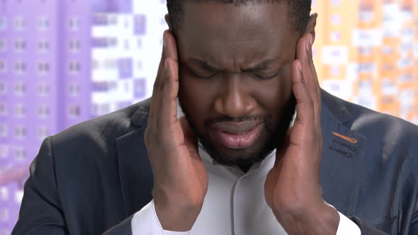 Close Up Black Businessman Suffering From Headache.