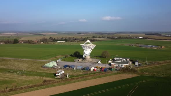 Wide angle establishing shot of radar antenna observatory in rural countryside