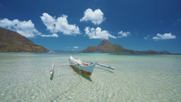 El Nido Bay. Palawan Island, Philippines. Slow Motion of Lonely Filippino Boat Floating in Calm Blue