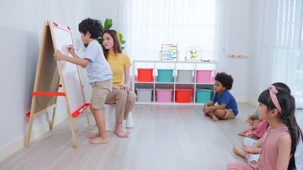 Asian beautiful young woman teacher teaching a lesson to kid at school. alt