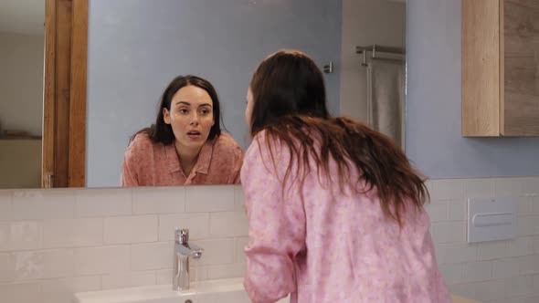 Happy woman enjoying good morning washing in bathroom