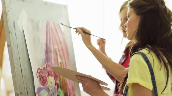 Student Girls with Easel Painting at Art School 