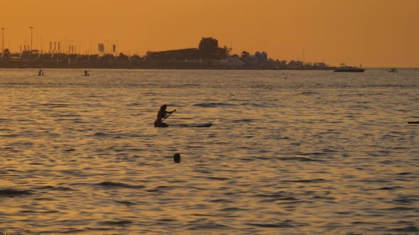 Silhouettes of People Surfers on the Sea at Sunset.