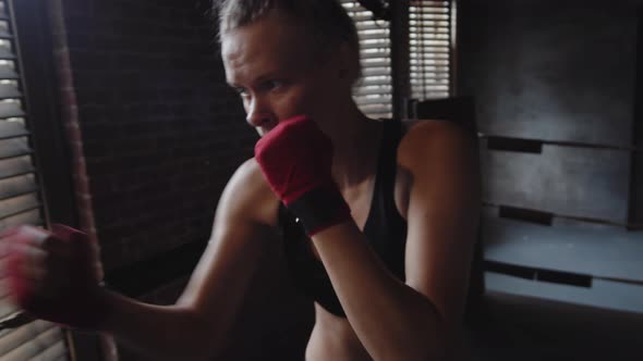 Blonde Female Boxer Exercising in Boxing Studio