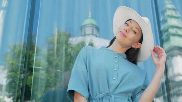 Portrait of Happy Stylish Charming young mixed race woman Fashion Blogger in blue summer dress and w