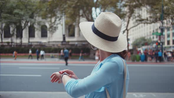 Young woman looking at watch