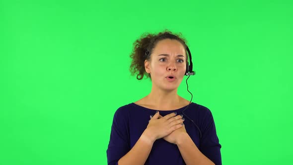 Portrait of Curly Woman Talking on Headphones, Call Center. Green Screen