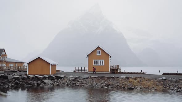 Hiker Walking Past Houses On Village