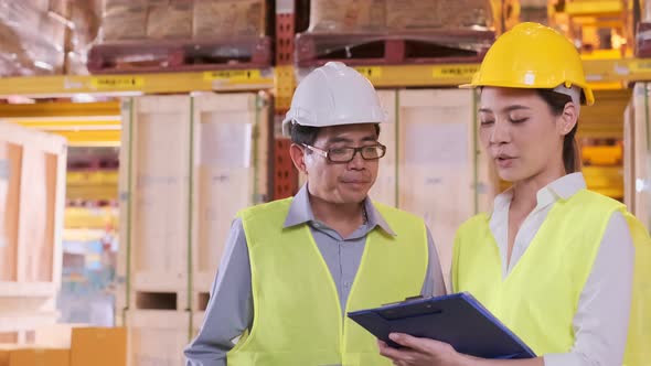 asian Male and Female Industrial Engineers in Hard Hats