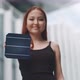 Young woman firmly holding a solar cell in her hand while smiling - VideoHive Item for Sale