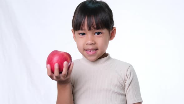 Happy little girl with apple.