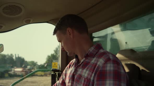 Tractor Driver Inside Cabin Checking Machinery Closeup