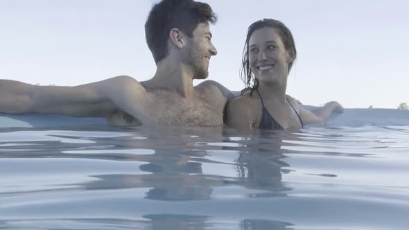 Couple relaxing in pool together