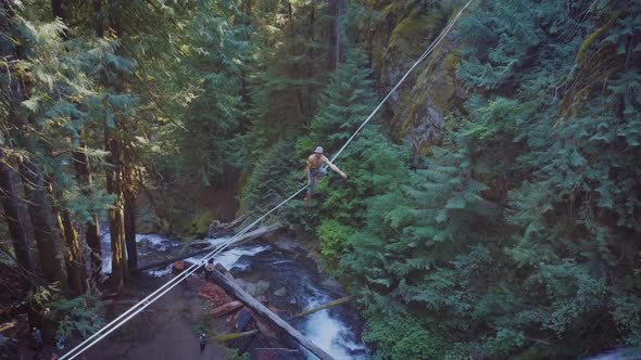 Fit Man High-lining Over A Waterfall