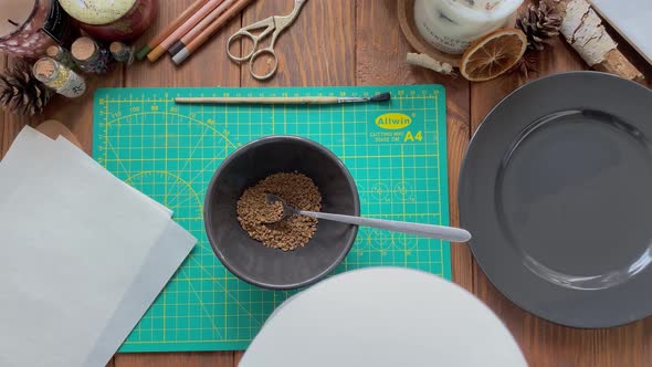 Person Pours Boiling Water From Teapot Into Cup with Coffee Granules