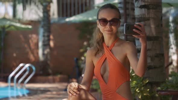 Girl Takes Photos Using Mobile Against Pool at Home