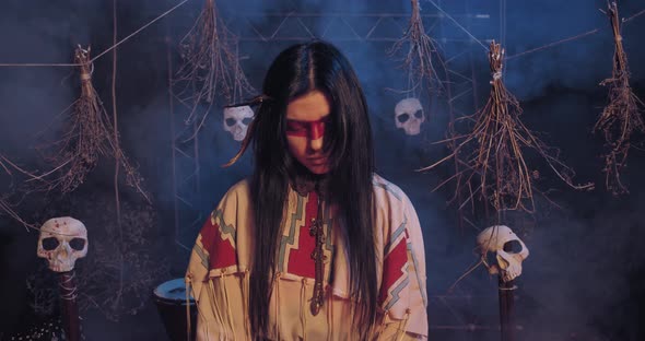 Young Indian Woman in Traditional Clothes and Skulls in the Background, 