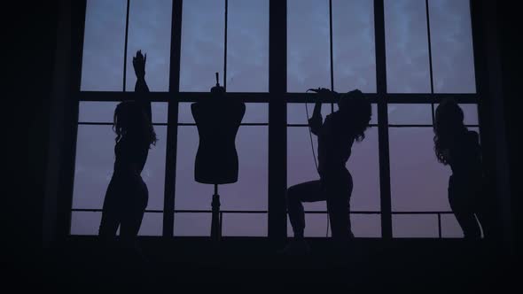 The Women's Music Group Is Filmed in a Music Video. They Dance and Sing in the Background of a Large