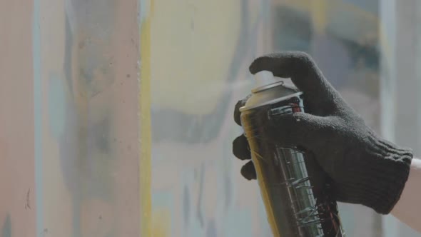 Close View of Hand in Black Gloves Drawing Graffiti on Wall with Balloon