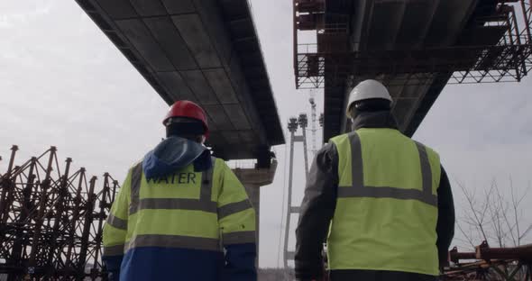 Unrecognizable Men Inspecting Bridge Construction Site