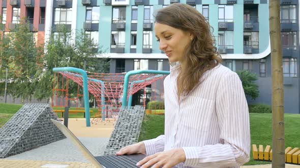 Young Woman is Having Online Meeting Using Her Laptop Businesswoman with Digital Tablet Outside on