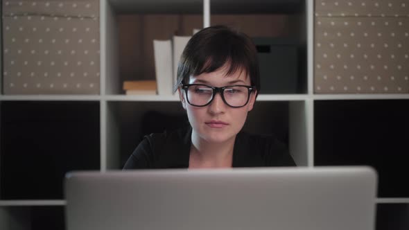 Female reads good news in email, rejoices victory, feels motivated. Excited young winner.