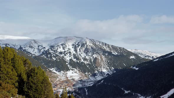 Static sunset mountain timelapse in Andorra. Clouds draw shadows on the snowy mountains. 4K. ProRes