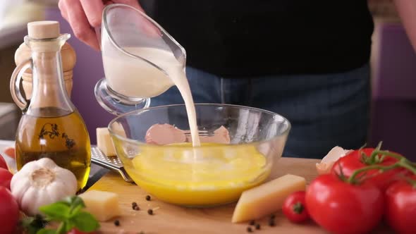 Making Pasta Carbonara  Pouring Cream Beaten Yolks in Glass Bowl