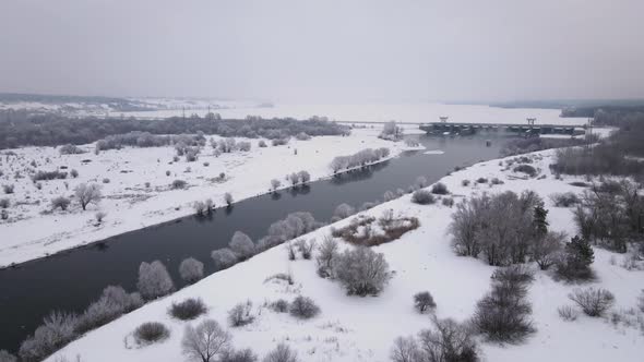 River in Winter Landscape with Shore Covered Snow