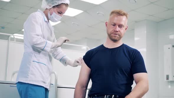 Doctor is Injecting a Man with Covid19 Vaccine