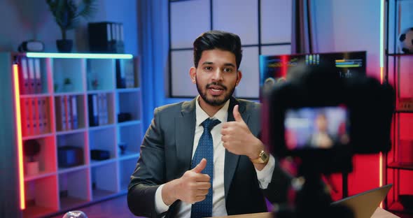 Office Manager in Suit Holding Online Conference on Camera and Showing Thumbs Up