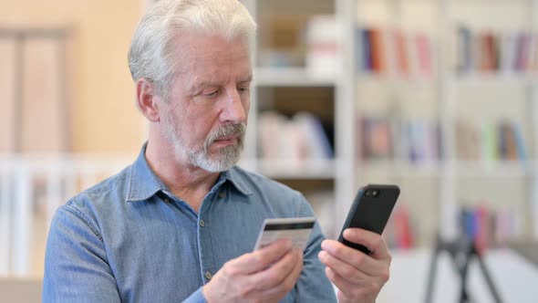 Old Man Doing Online Payment on Smartphone