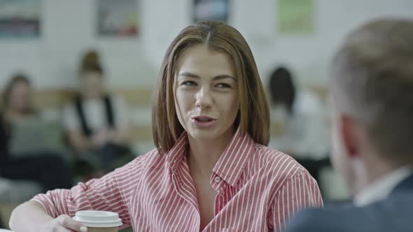 Beautiful Businesswoman Chatting with Coworker