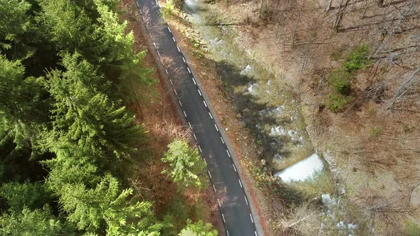 Aerial View of Road near Water and Forest