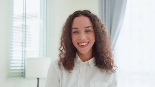 Portrait of Latino Beautiful girl in pajamas smile and look at camera after wake up early from bed