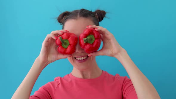 Woman Holds Pepper in Her Hands Like Eyes