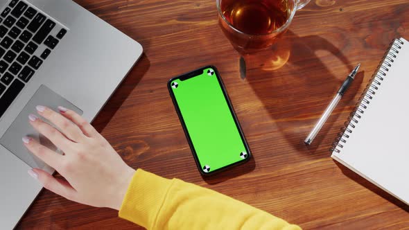 Businesswoman Using Laptop Computer Smartphone with Green Screen Top View