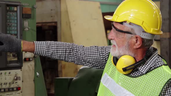 Senior Factory Worker Teach How to Use Machine Equipment in the Factory Workshop