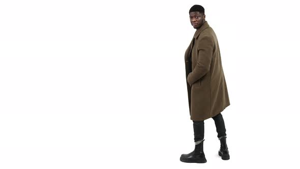 Elegant African Man Wearing Winter Coat and Turning to the Camera Isolated on White Background Copy