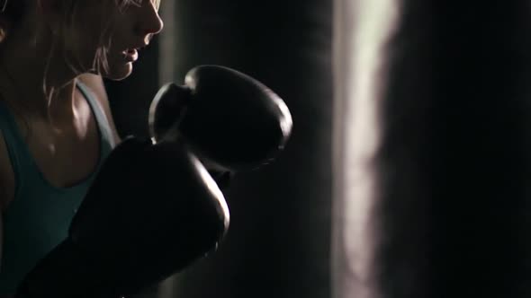 Woman does Muay Thai kickboxing training at the gym.