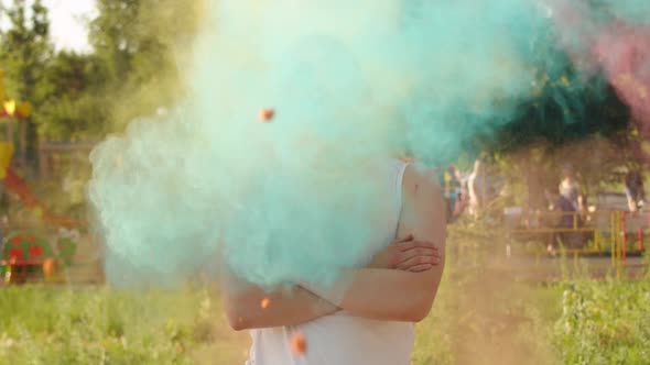 A Guy in a White Tank Top and Sunglasses Stands with His Arms Crossed Holly's Bright Paint Flying at